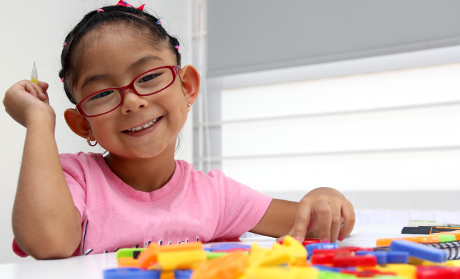 A child playing with toys on a table